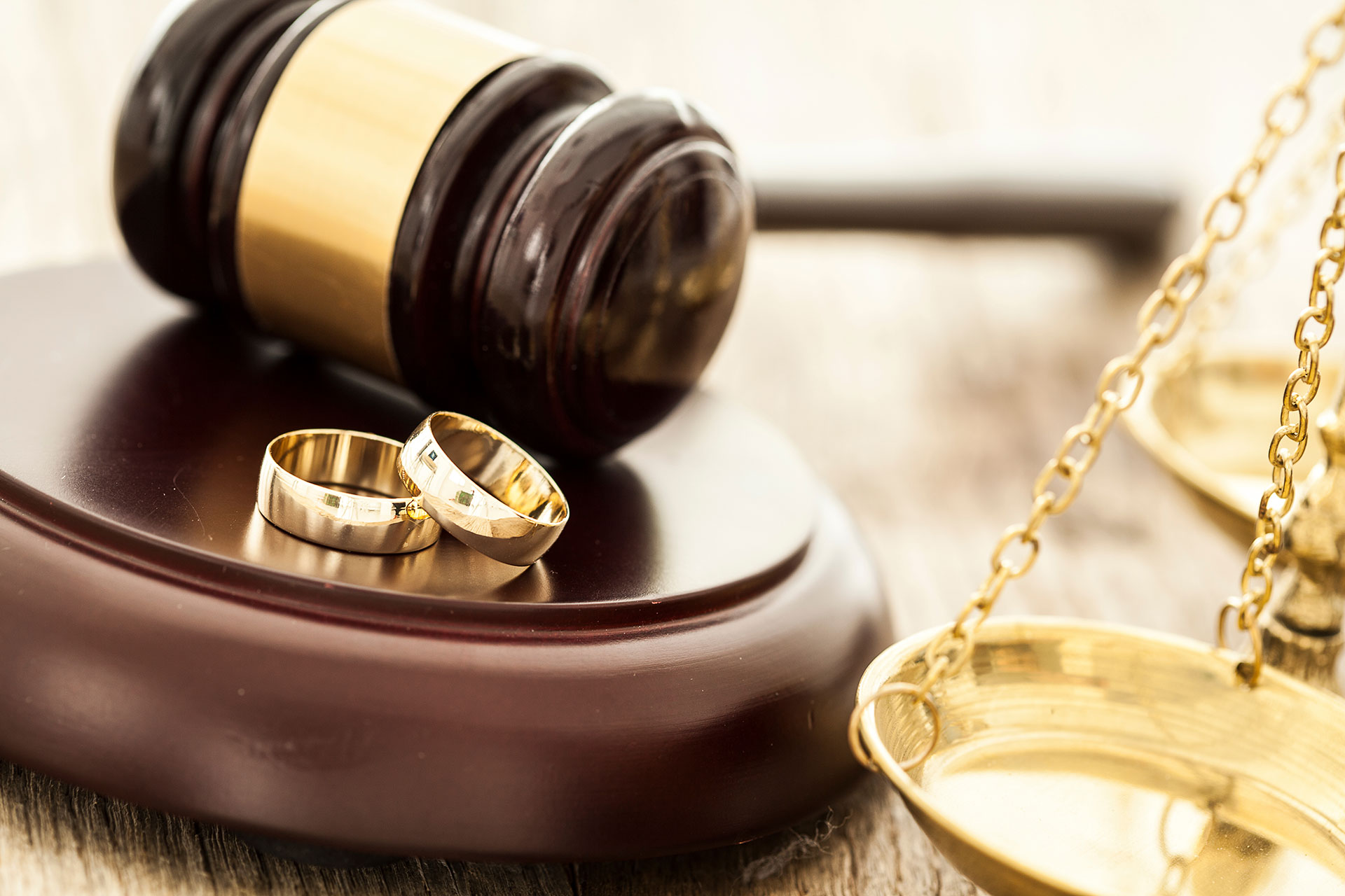 a gavel with wedding rings